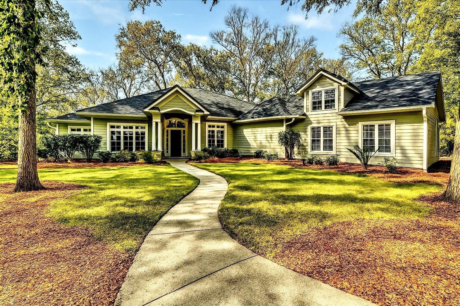Large two-story home with manicured lawn in Gainesville, Florida